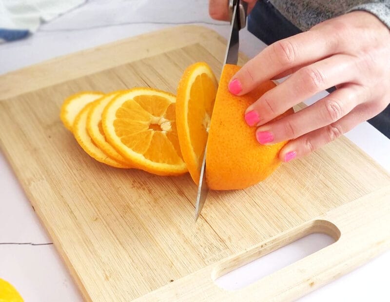 Cut the oranges into thin, even slices